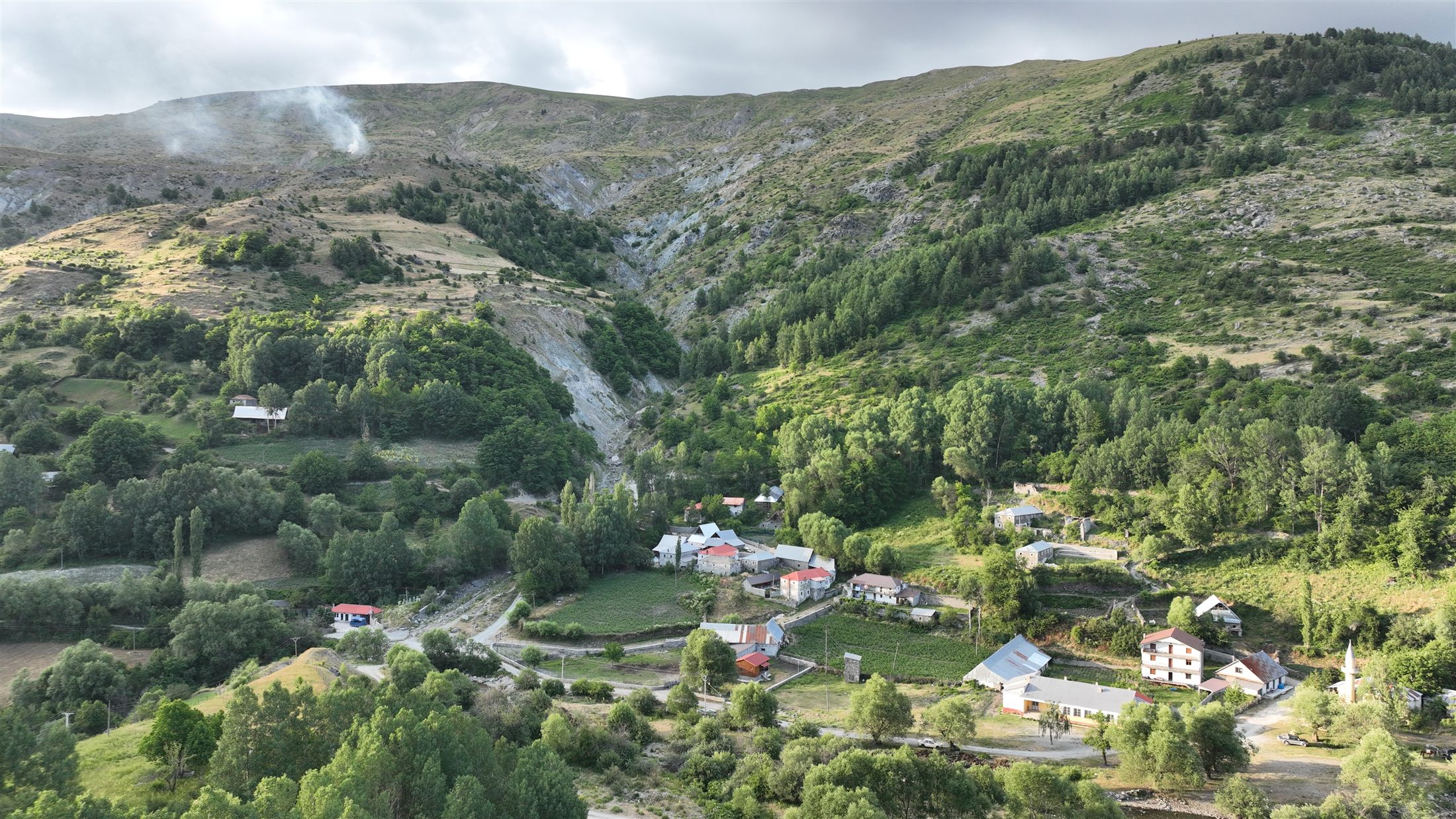 Çajë village tucked into a green mountain valley