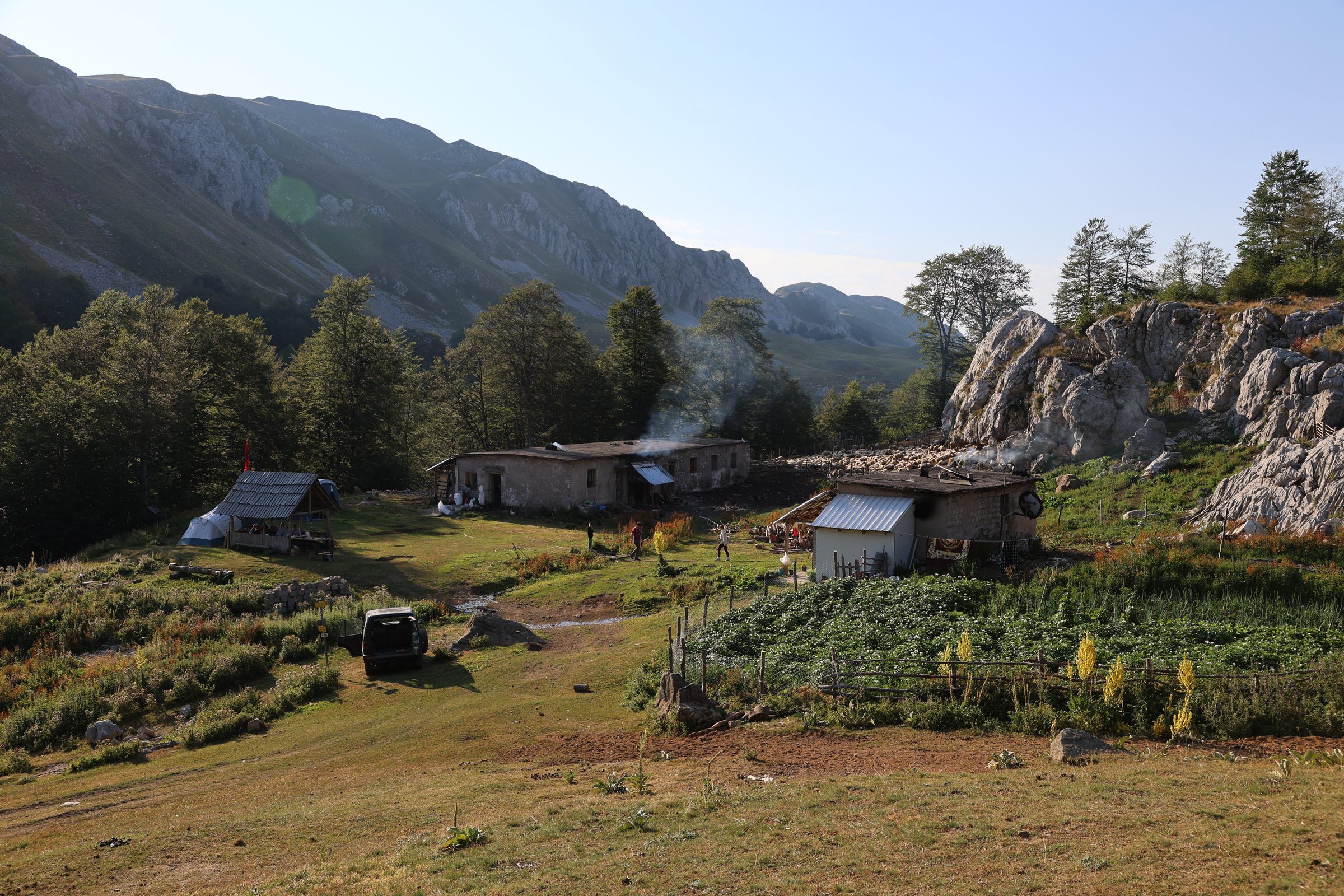 Smoke rising over the stone shepherd huts at Qarrishte at sunrise