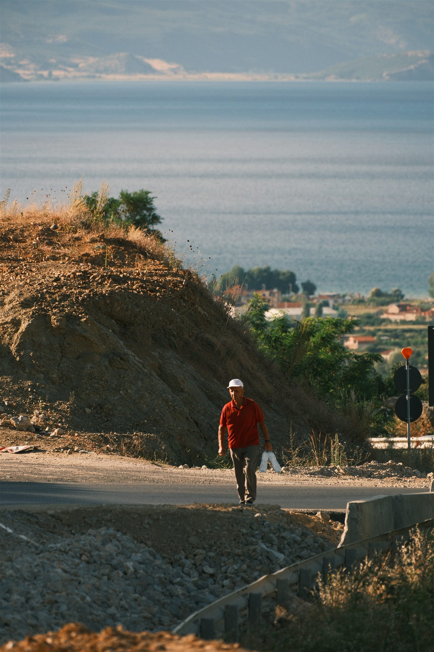 A walk along the lakeshore road near Tushemisht at golden hour